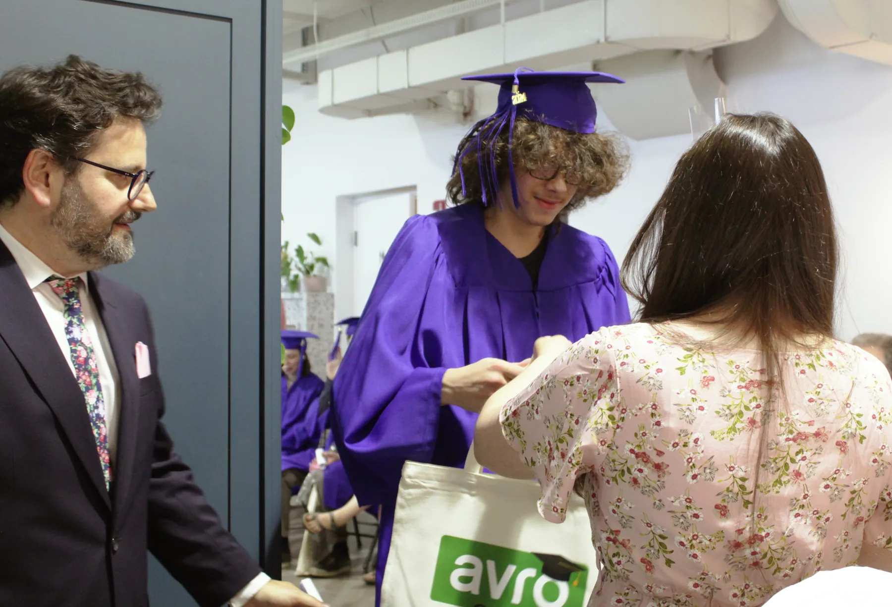 An AVRO Academy teacher with students on graduation day