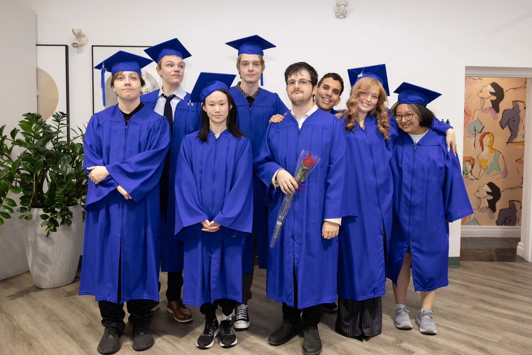 AVRO Academy graduates together in caps and gowns on graduation day