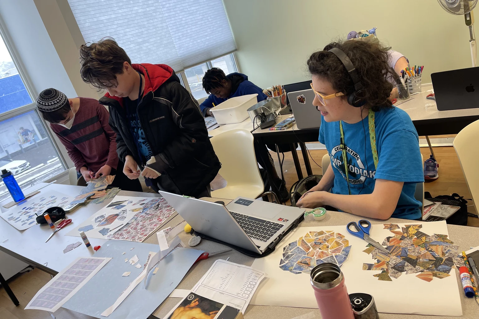 AVRO Academy students collaborating on a project at a shared table