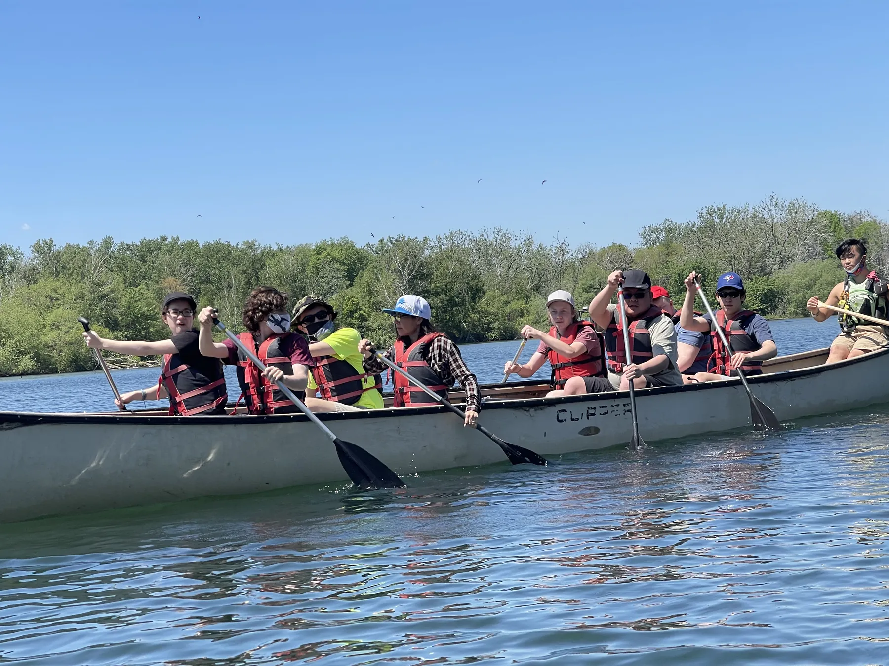 AVRO Academy students paddling a canoe outdoors